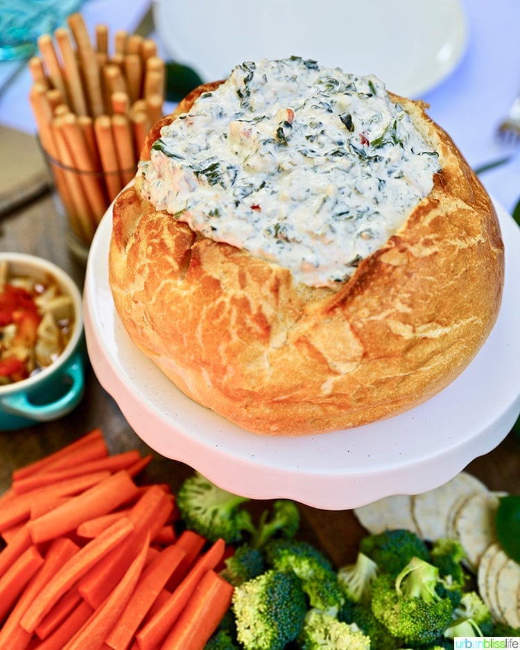 spinach dip in bread bowl with veggies