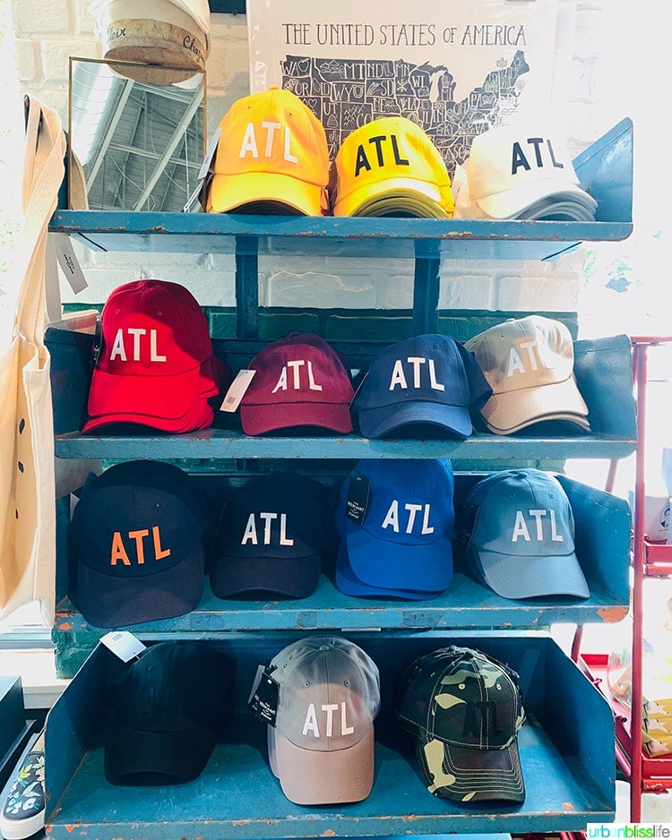 display full of colorful ATL baseball hats.