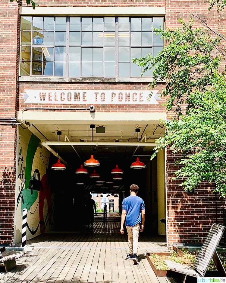 exterior of building with "Welcome to Ponce" sign above entrance.