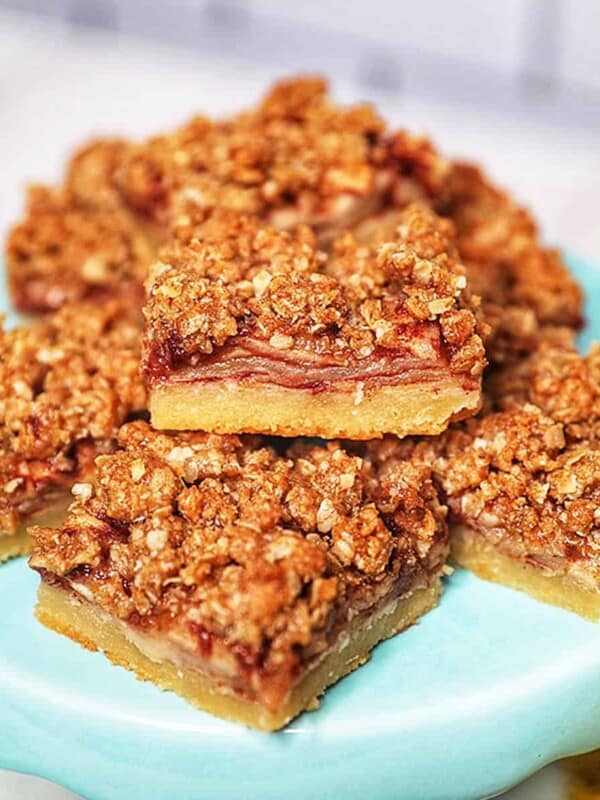 stack of apple pie bars on a light blue cake pedestal