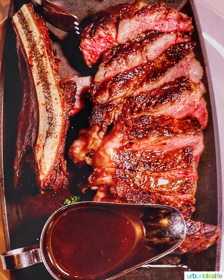 rib eye steak sliced with a side of au jus  at RingSide Steak House in Portland, Oregon.
