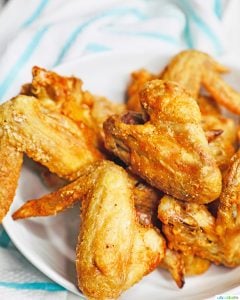crispy air fryer chicken wings in a bowl with towel