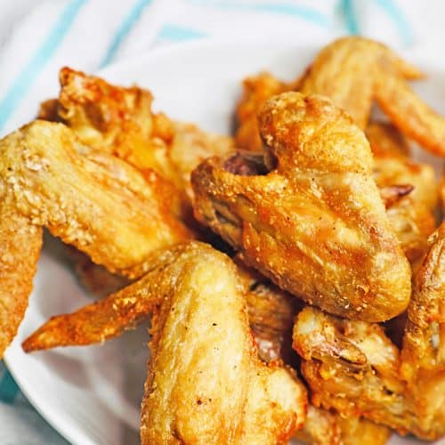 crispy air fryer chicken wings in a bowl with towel