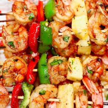 closeup of several grilled shrimp pineapple skewers served together