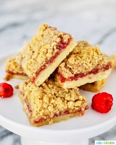 stack of Raspberry Crumble Bars on pedestal