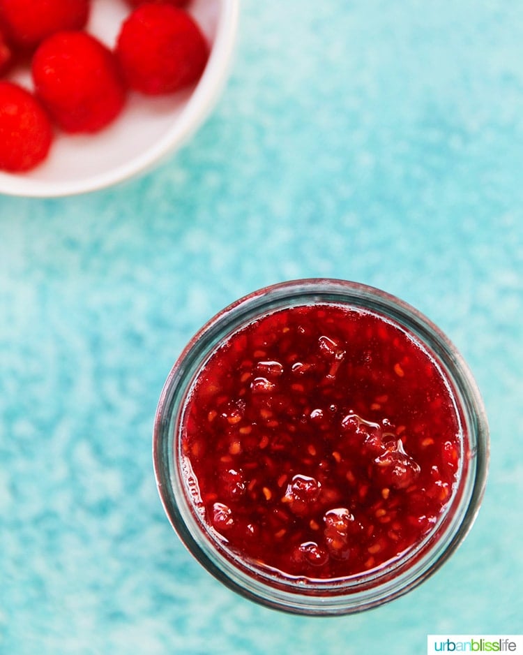 Raspberry jam in a jar with raspberries