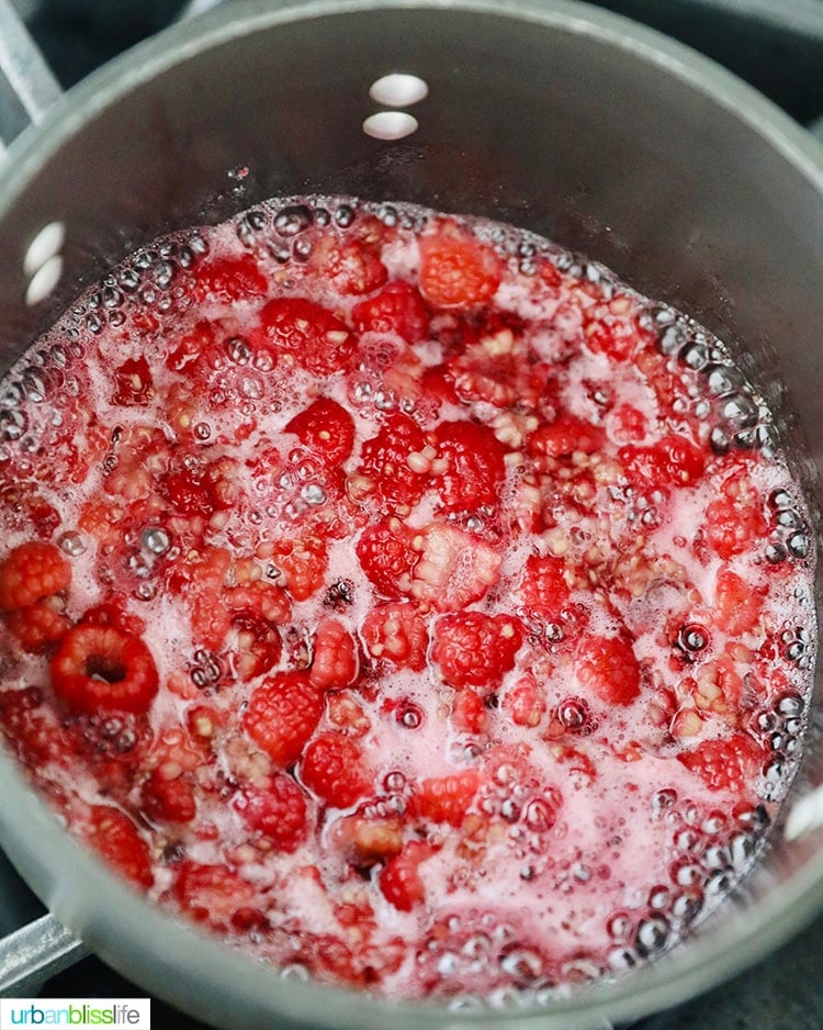 Raspberry jam cooking on stovetop