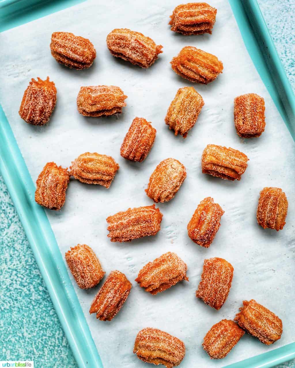 churros sprinkled on a baking tray