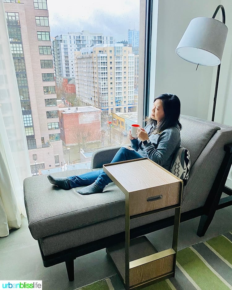 Marlynn in window seat overlooking the Pearl District at Canopy Hilton hotel