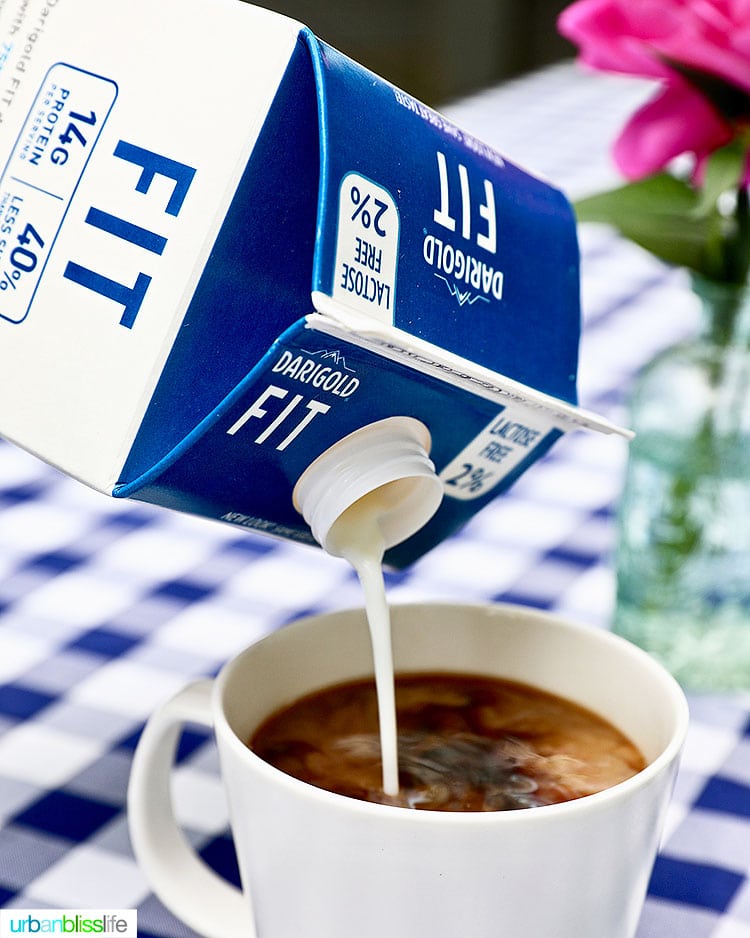 pouring ultra-filtered milk into a cup of coffee