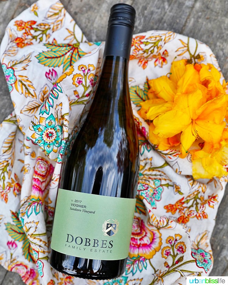 bottle of Dobbes Winery Viognier with colorful napkin and flowers