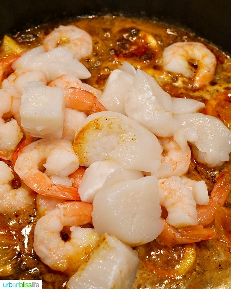 adding shrimp and scallops to the bbq sauce
