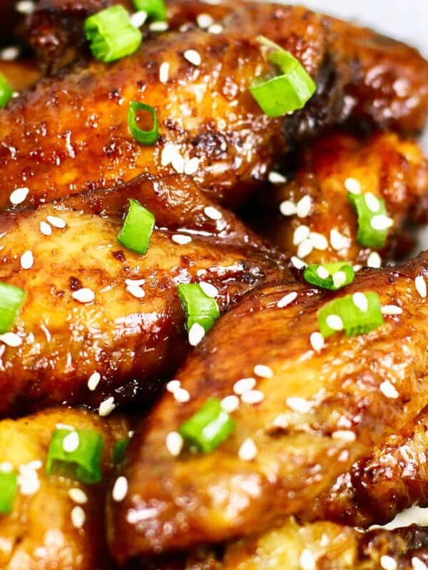 baked teriyaki chicken wings with sesame seeds and sliced green onions.