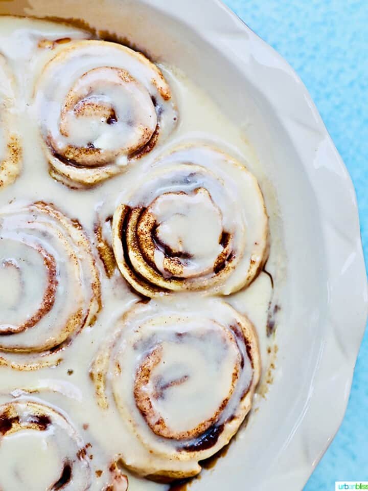 half pan of orange cinnamon rolls with icing