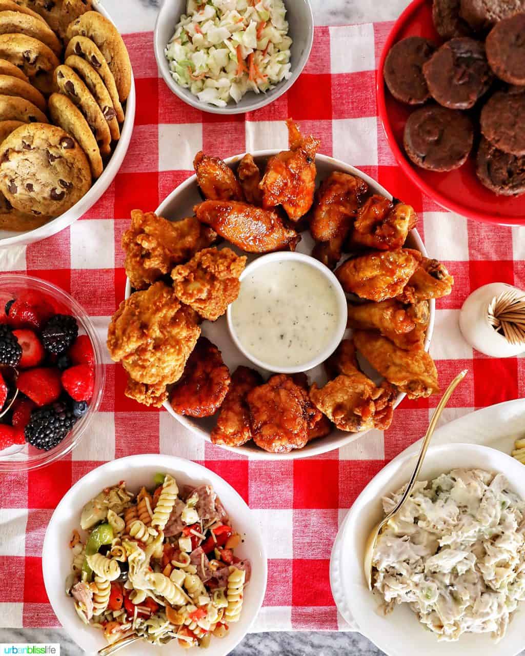 tailgating food on red checkered tablecloth