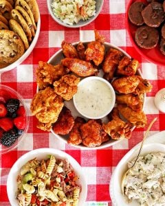 tailgating food ideas: chicken wings, pasta salad, chicken salad, cookies, brownies