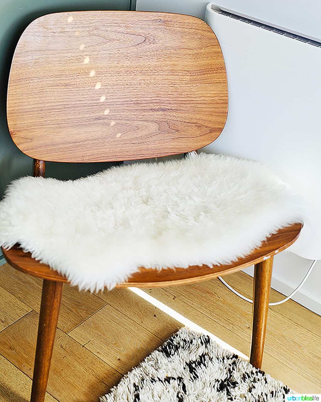 mid-century modern chair with fuzzy throw