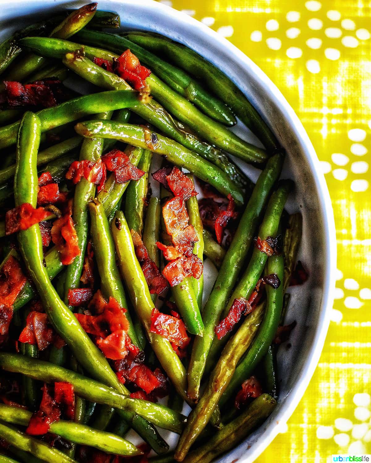 half bowl of green beans with bacon