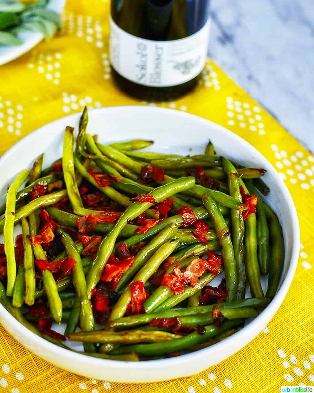 green beans with bacon with bottle of wine