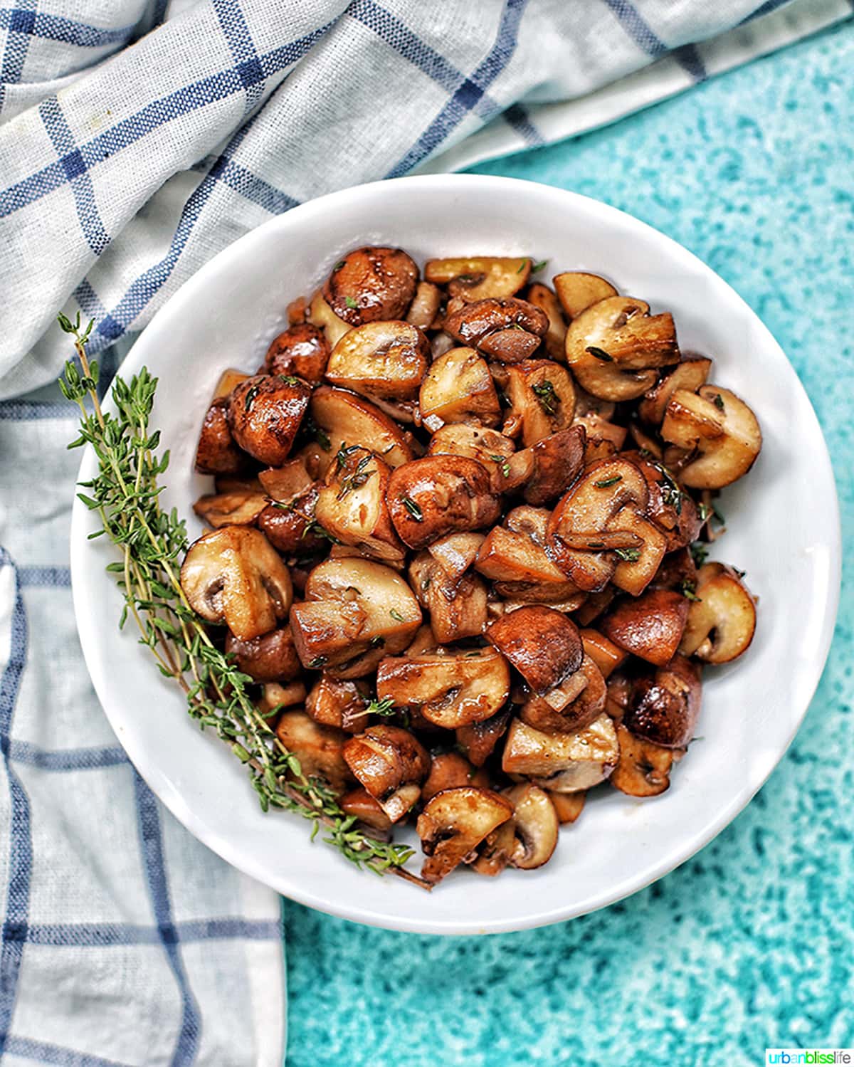 bowl of mushroom marsala with blue background and kitchen towel