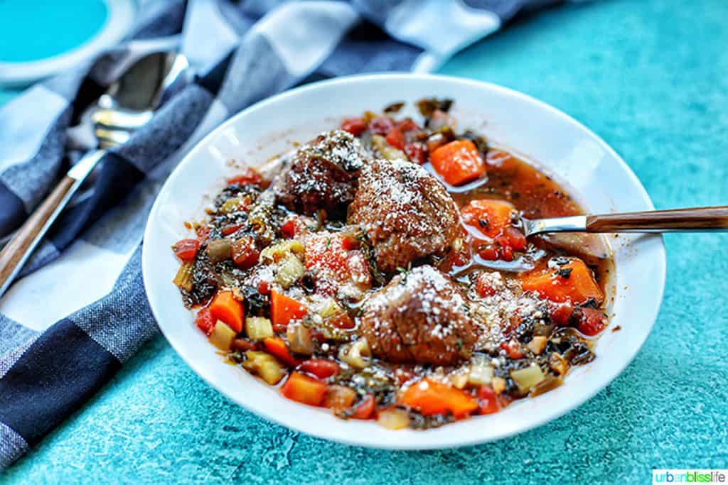 landscape photo of meatball soup with parmesan cheese