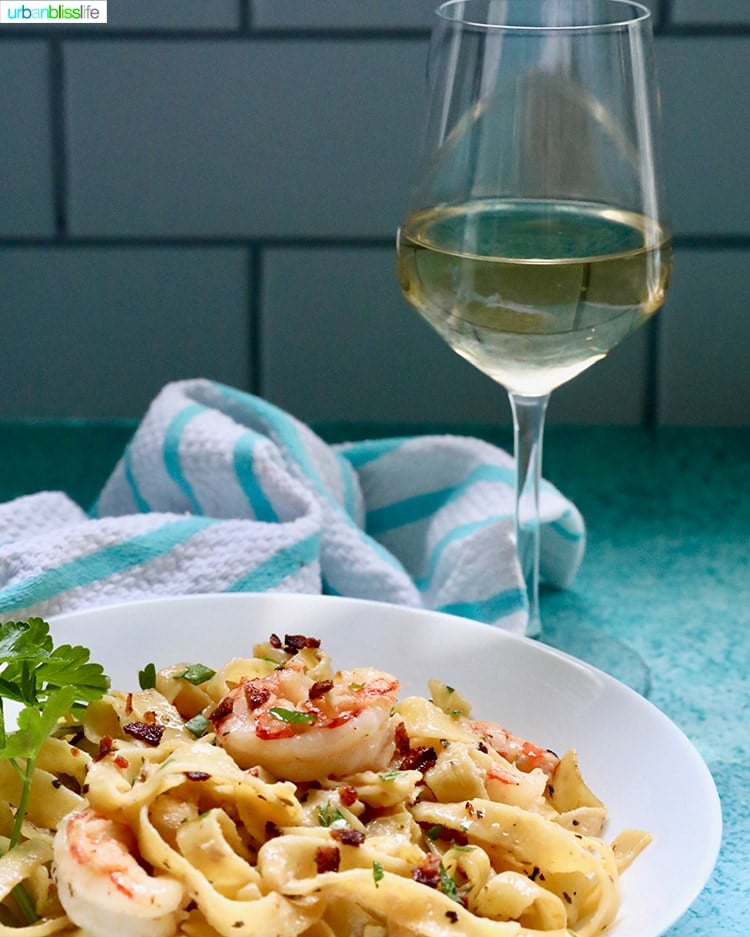 shrimp pasta with glass of white wine