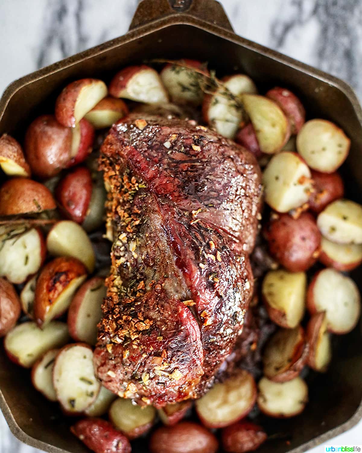 beef roast with potatoes in cast iron skillet 