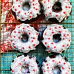 six mini gingerbread bundt cakes on a baking rack with red and white napkin
