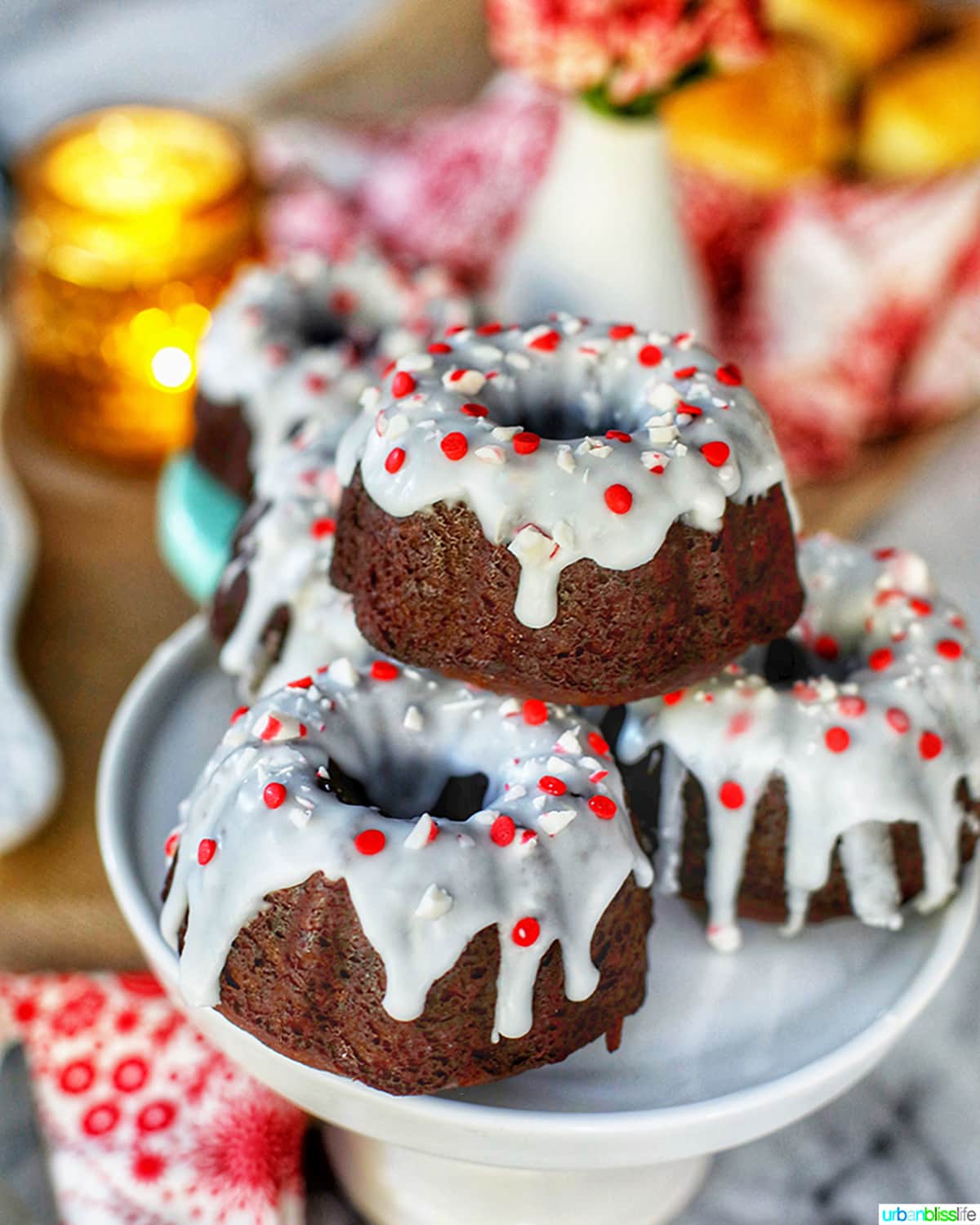 mini gingerbread bundt cakes stacked on white pedestal