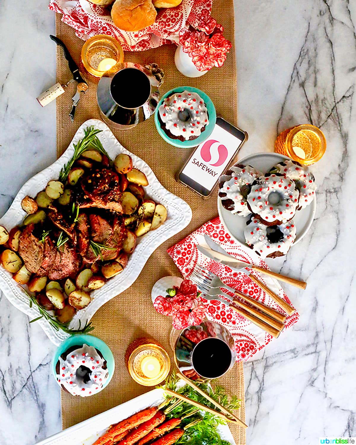 holiday dinner: beef roast, gingerbread bundt cakes, wine, dinner rolls, on a table decorated for the holidays