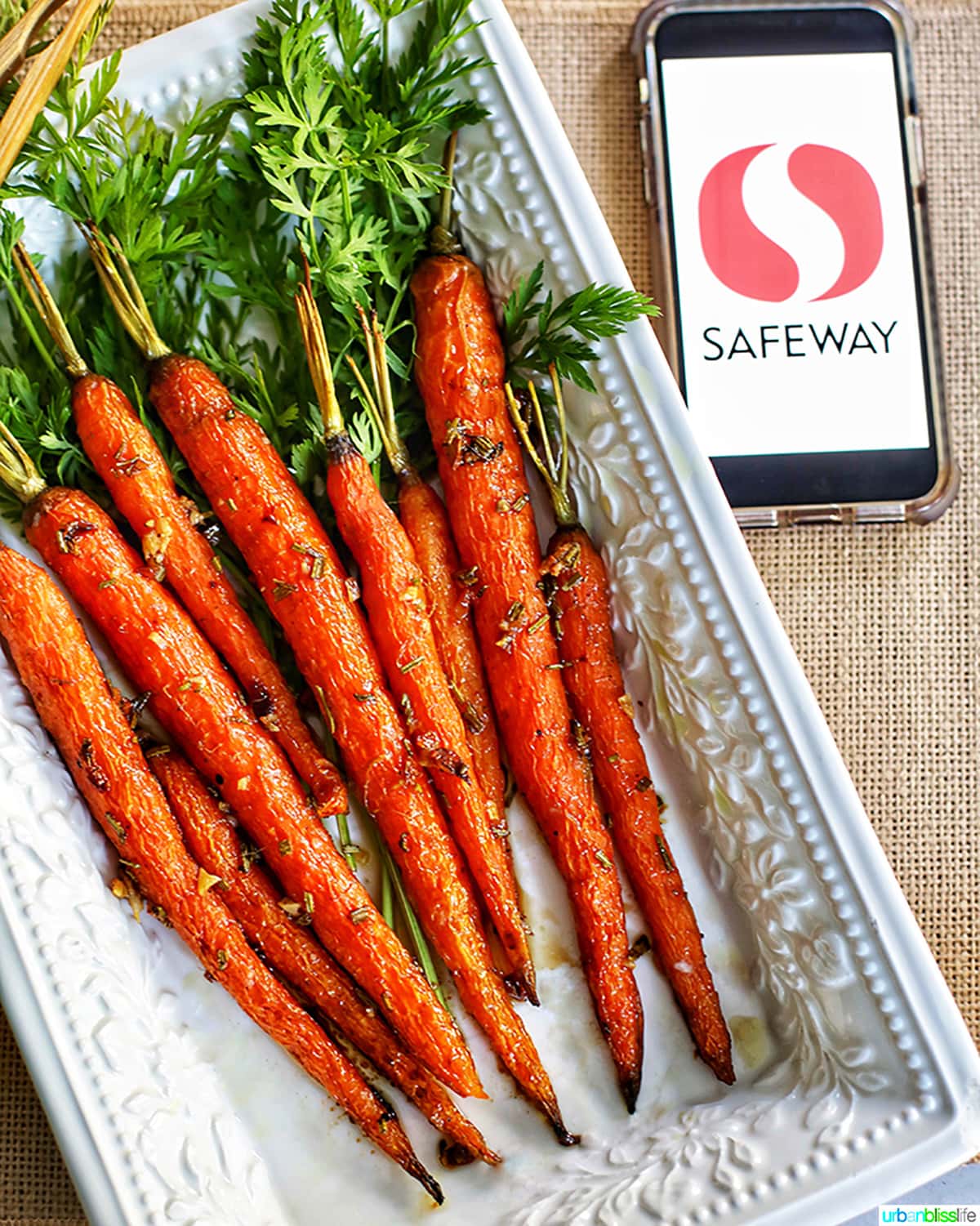 glazed carrots on white plate with safeway logo on phone