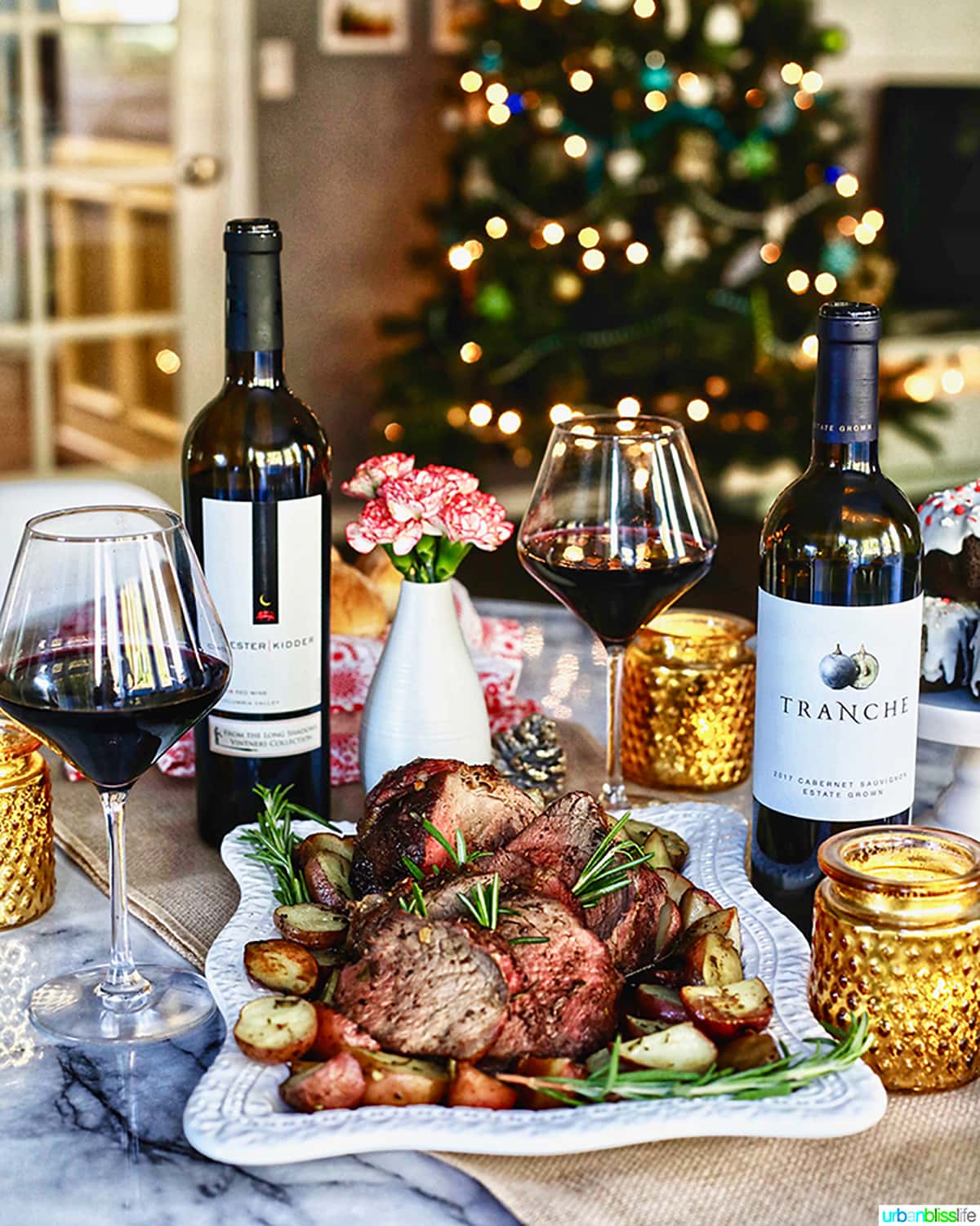 red wine bottles on a table for Thanksgiving Christmas holiday scene with roast and potatoes.