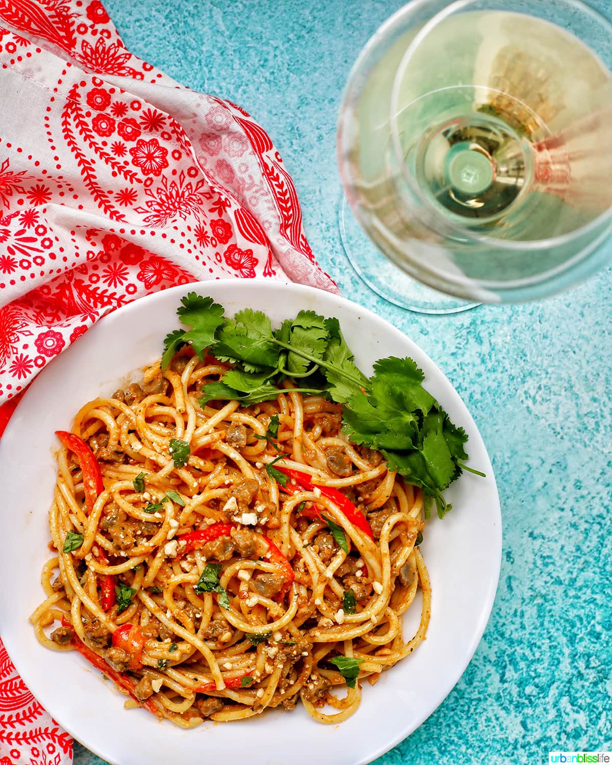 Thai Red Curry Pasta with glass of white wine