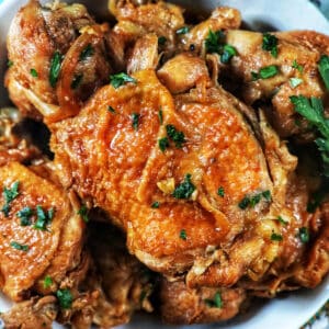 bowl of Instant Pot Filipino Chicken Adobo with herbs.