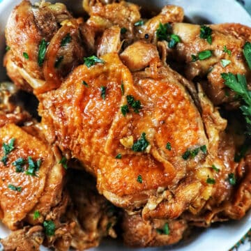 bowl of Instant Pot Filipino Chicken Adobo with herbs.