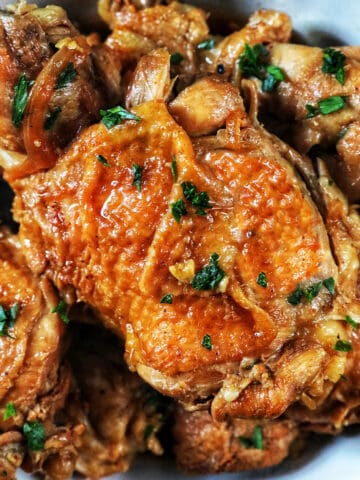 bowl of Instant Pot Filipino Chicken Adobo with herbs.
