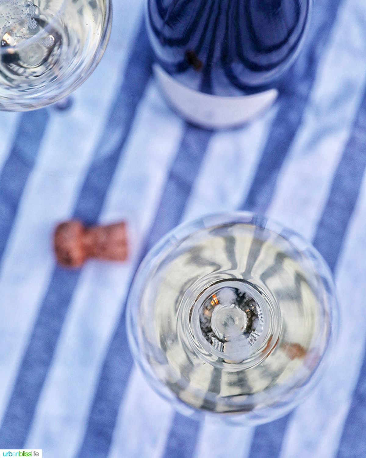 champagne in glass with cork and bottle