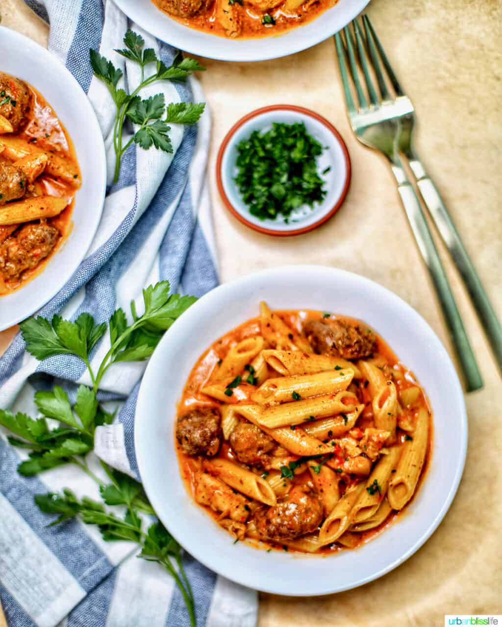bowls of Instant Pot Cajun Chicken Pasta with forks