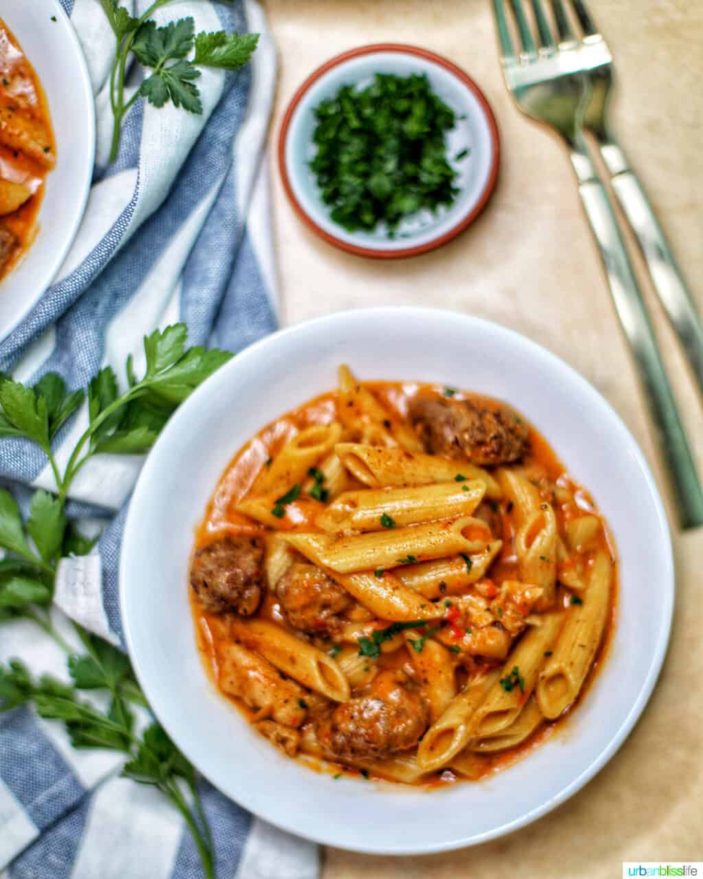 bowls of Instant Pot Cajun Chicken Pasta with forks