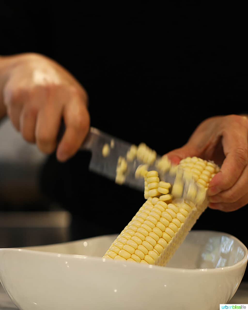 scraping the corn kernels off the cob