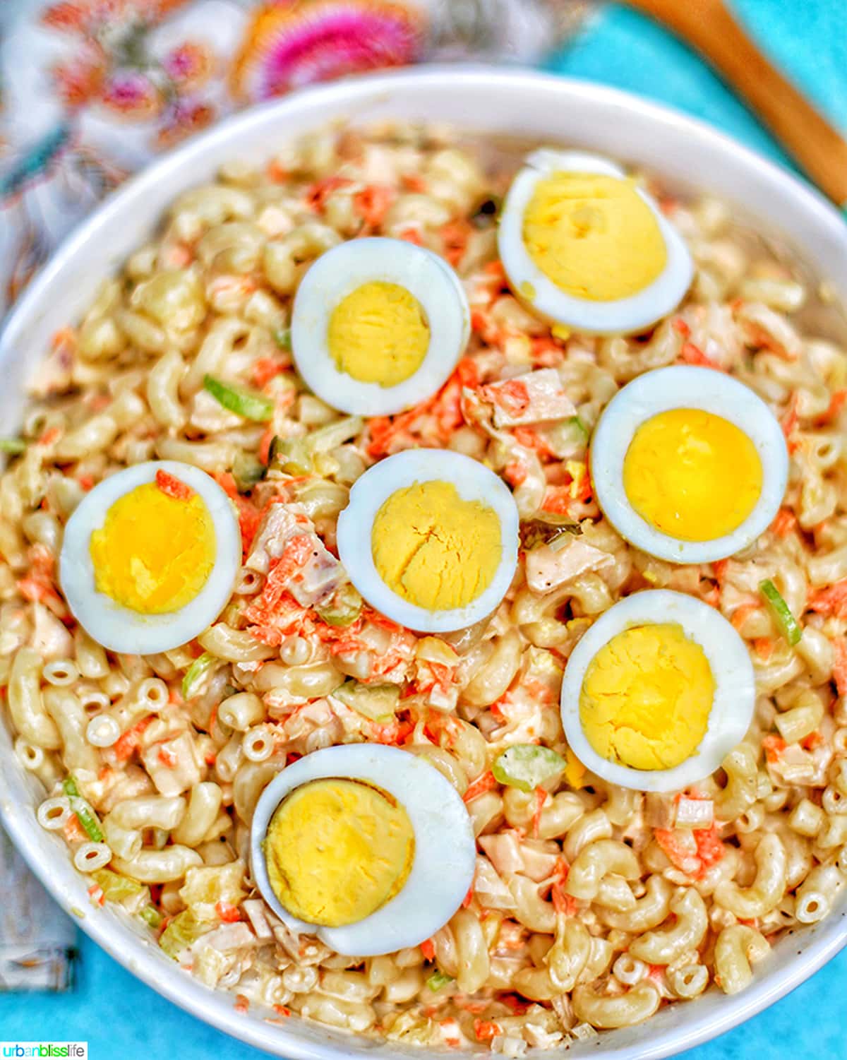 Filipino Macaroni Salad - macaroni, carrots, chicken, celery, pineapple, sliced hard-boiled egg- in a bowl.