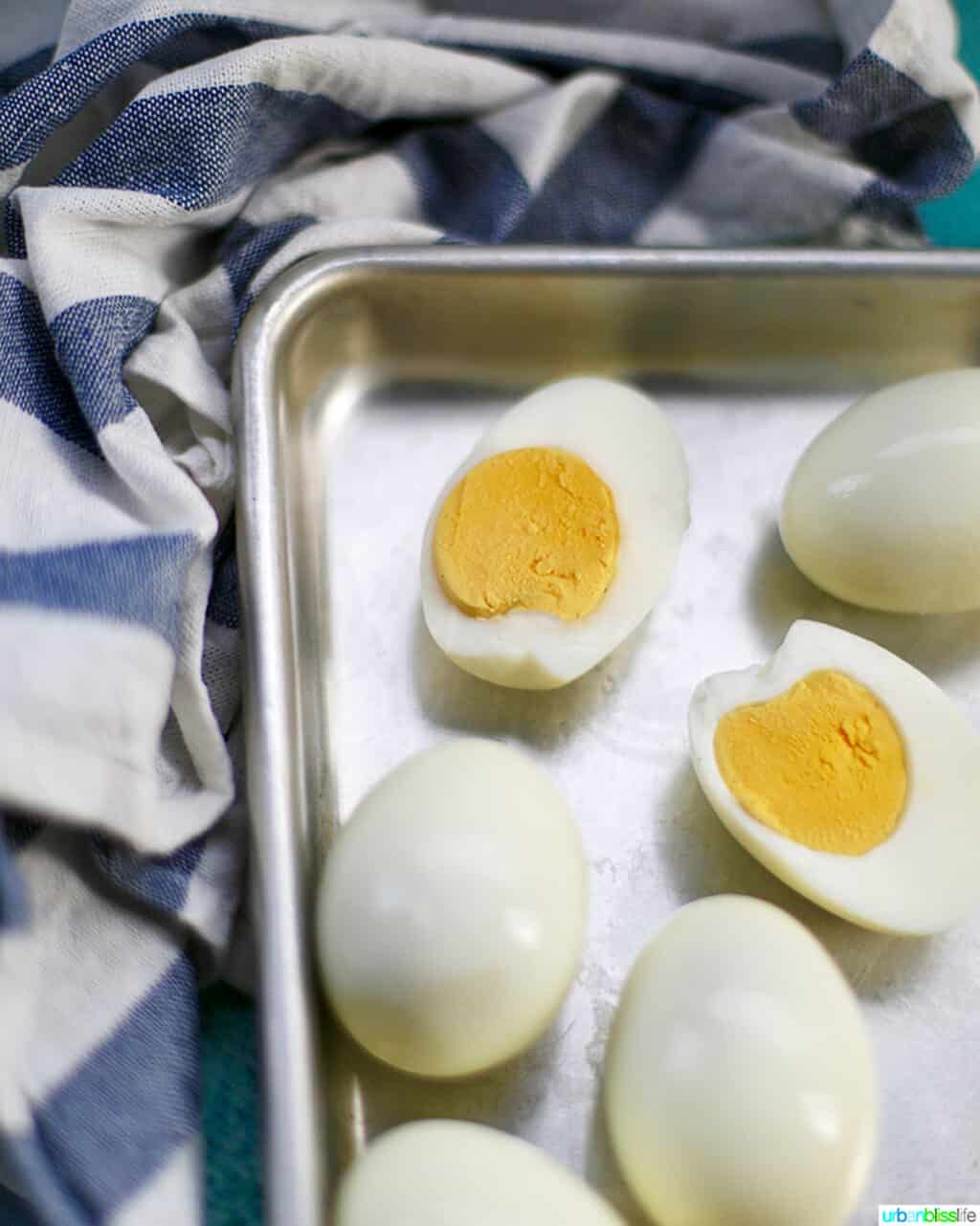 Hard boiled eggs one cut open on a baking sheet 