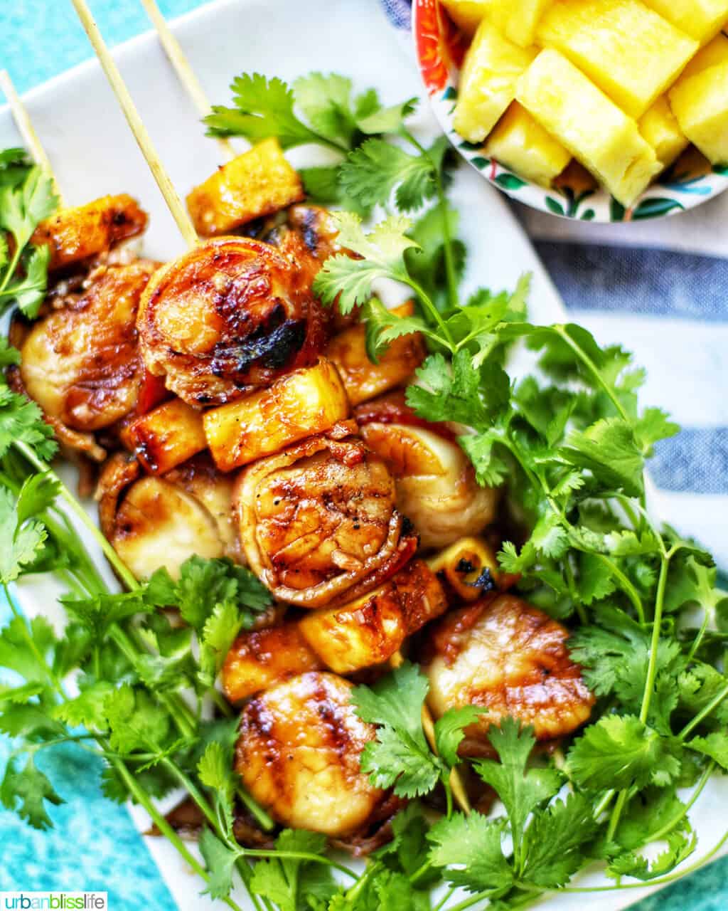 grilled bacon-wrapped scallop skewers with pineapple and parsley