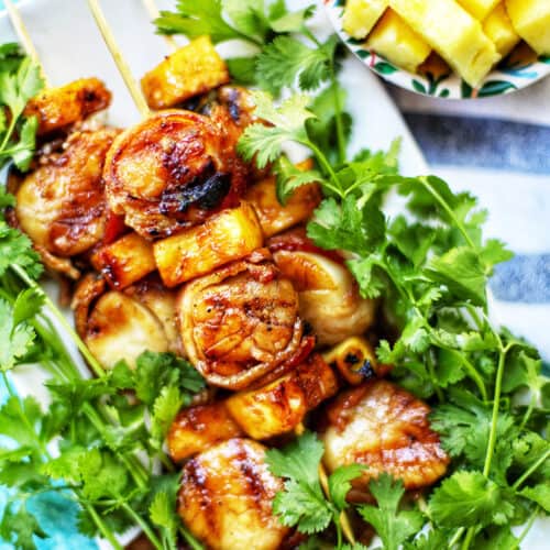 grilled bacon-wrapped scallop skewers with pineapple and parsley