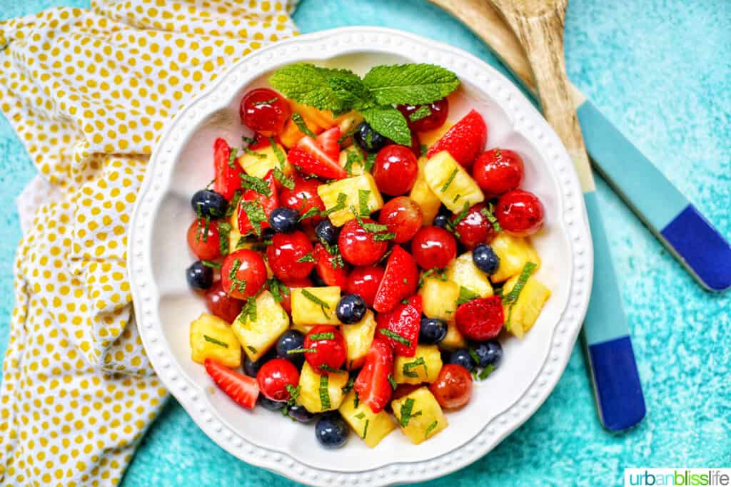 landscape photo of simple fruit salad with salad tongs