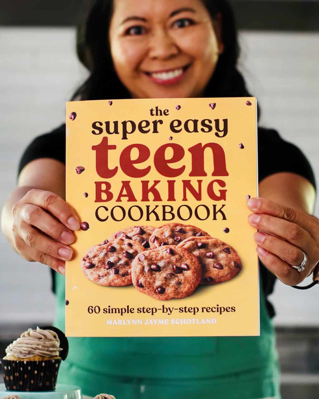 Marlynn holding out Super Easy Teen Cookbook