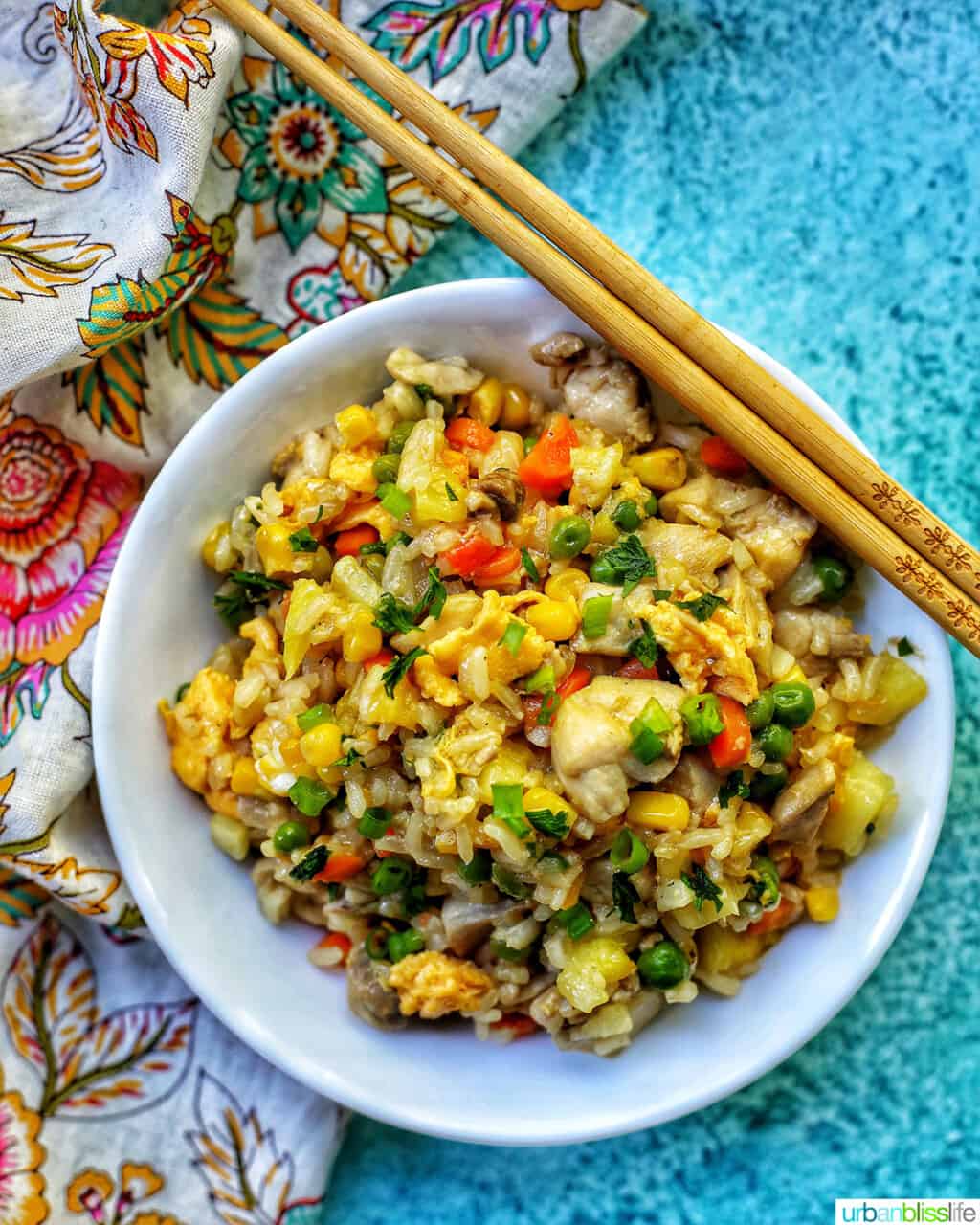 bowl of pineapple fried rice with chopsticks