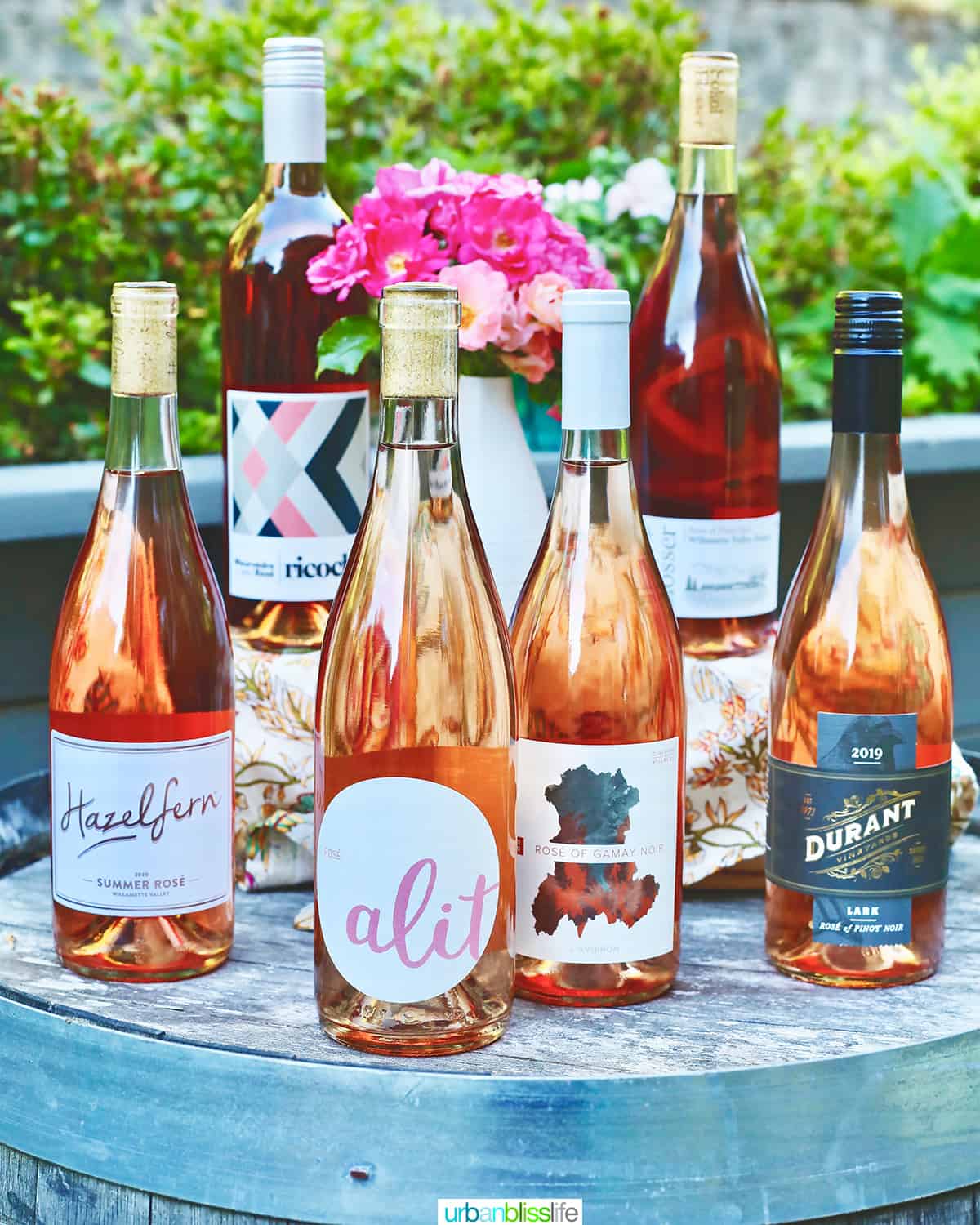 7 bottles of the best rosé wines to drink in 2021 on a wine barrel.