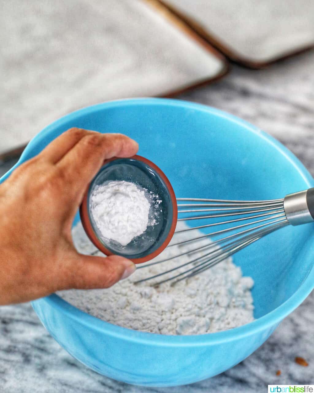 adding baking powder to flour