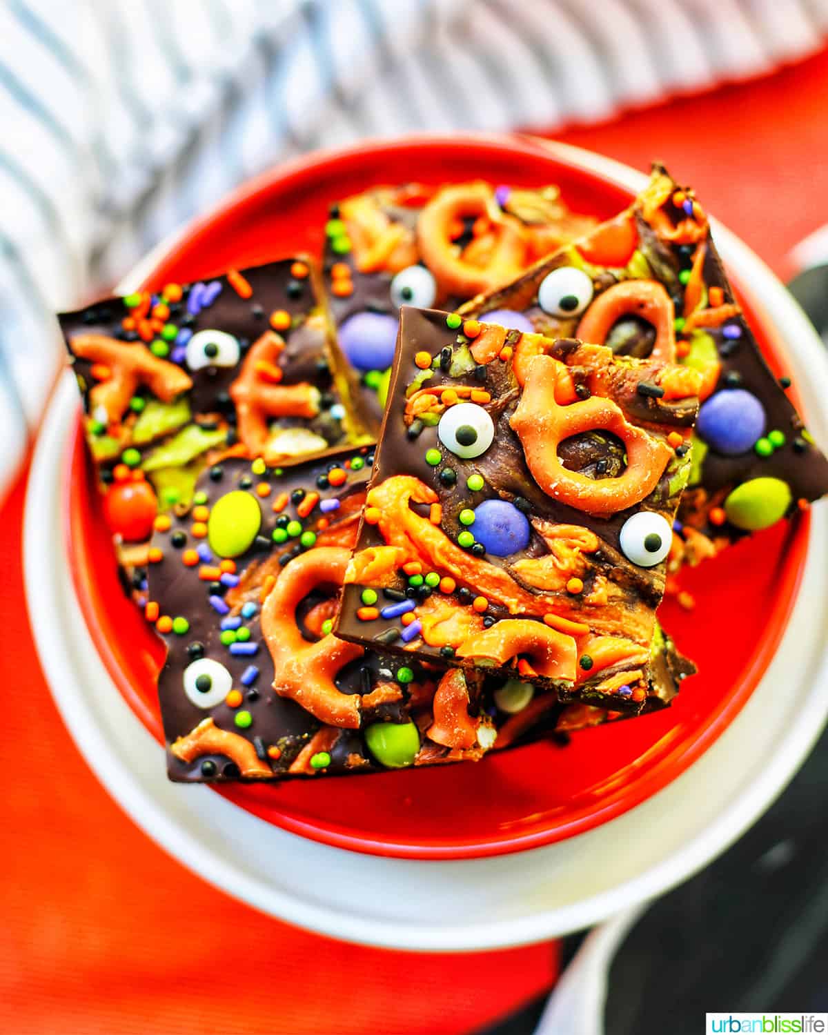 Monster Halloween Bark squares on orange and white plates